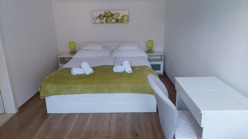 A bed or beds in a room at Orchidea Veszprém Apartman