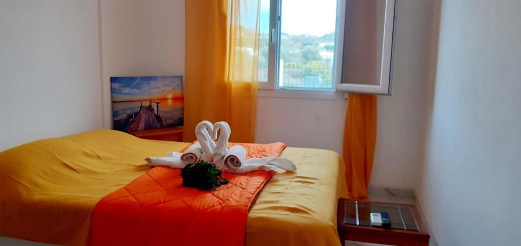 a bedroom with a bed with two rabbits on it at Ammoudaries appartment in Lakkíon