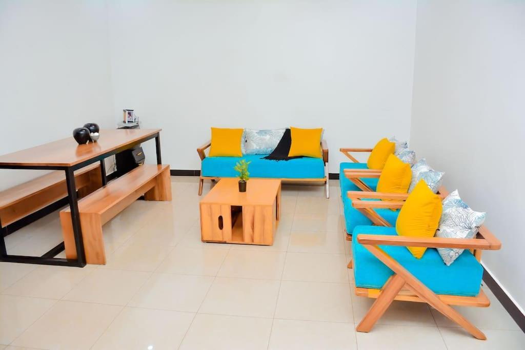 uma sala de estar com duas cadeiras e uma mesa em Iwawe by IBC- Room 1 em Kigali
