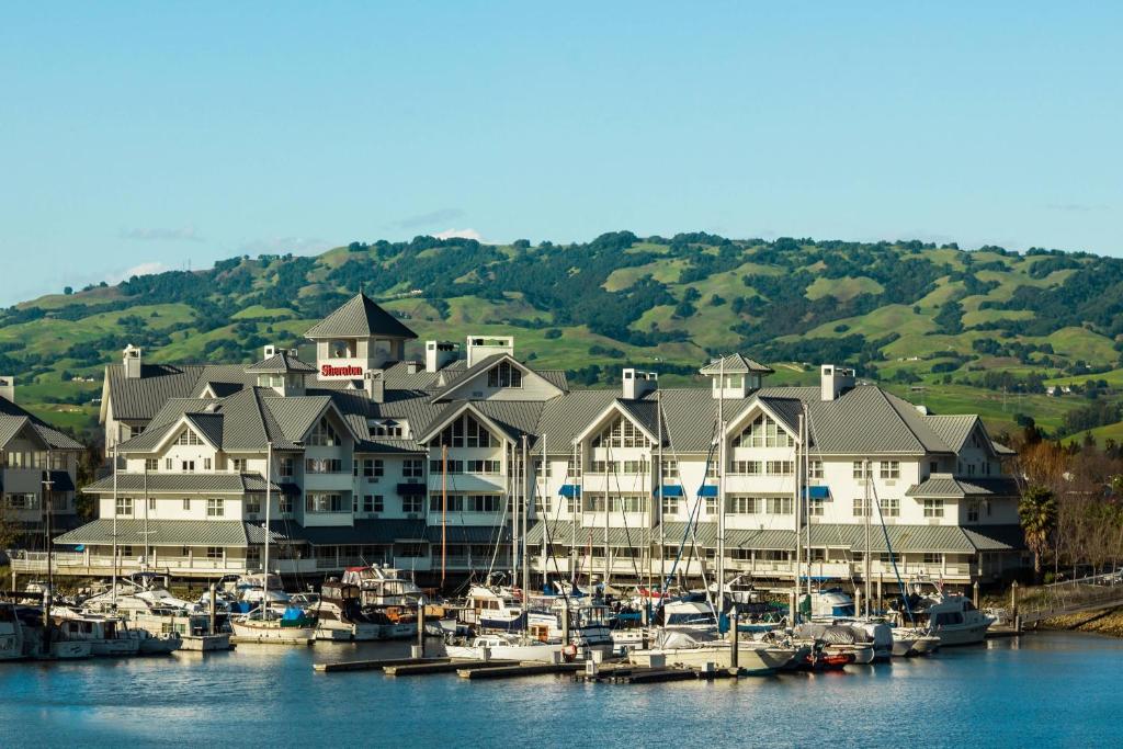 a large building with boats docked in a marina at Sheraton Sonoma Wine Country Petaluma in Petaluma