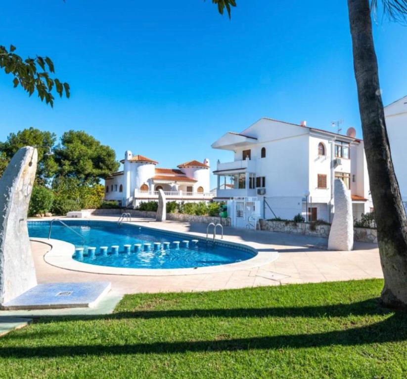 a swimming pool in front of a house at EL MARINERITO Alcocebre in Alcossebre