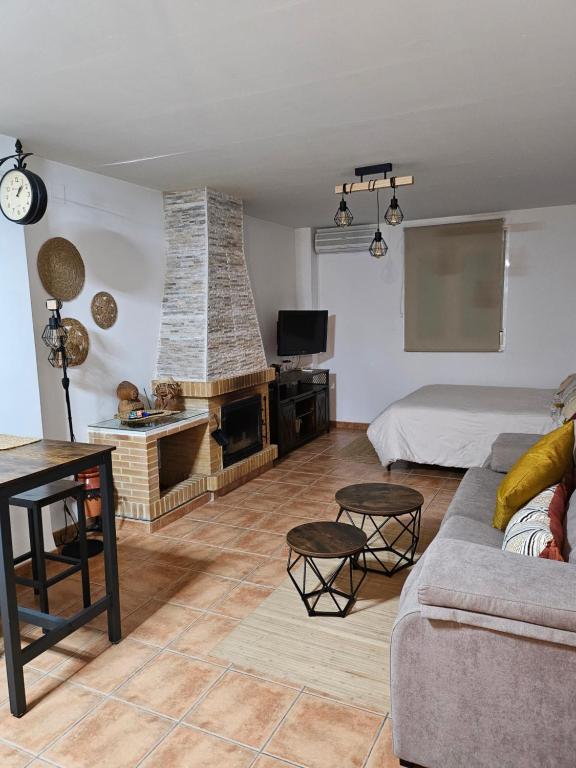 a living room with a couch and a fireplace at Loft Aguas de la Sierra in Benamahoma