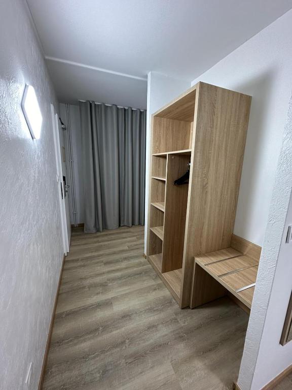 a room with a book shelf and a closet at Hôtel NOROTEL in Brumath