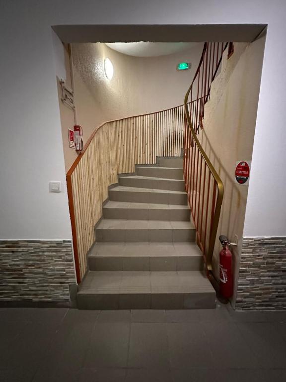 a staircase in a building with a red fire hydrant at Hôtel NOROTEL in Brumath
