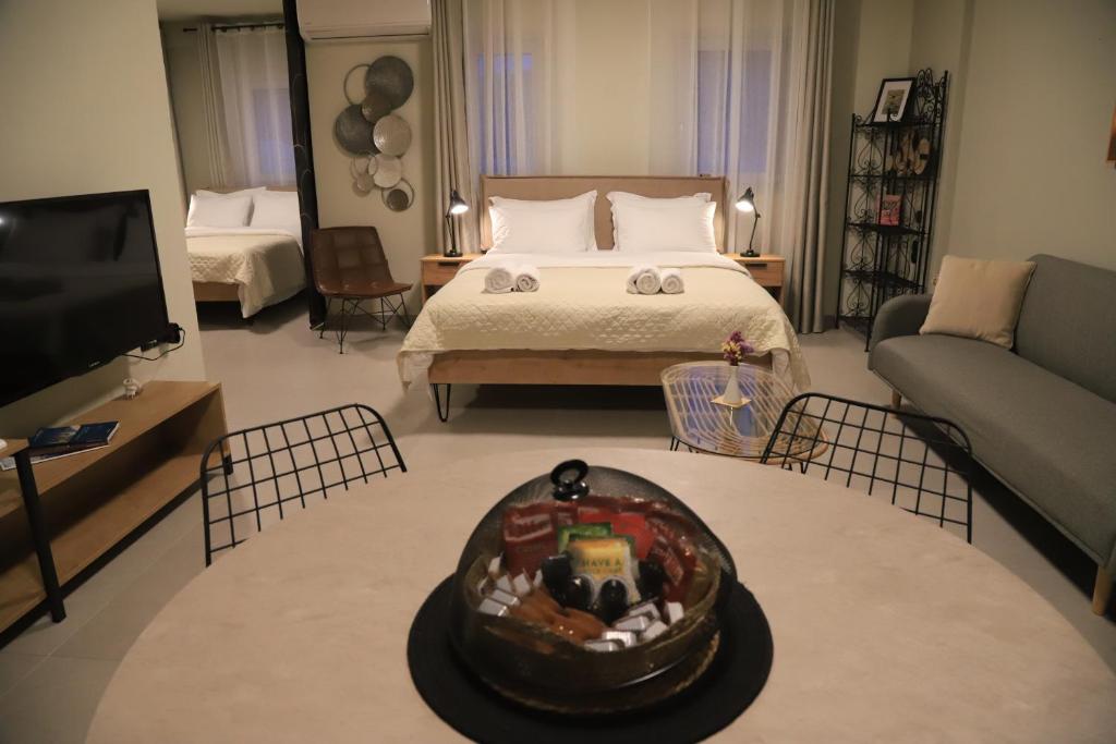 a living room with a bed and a tv at Cruzeto in Syvota