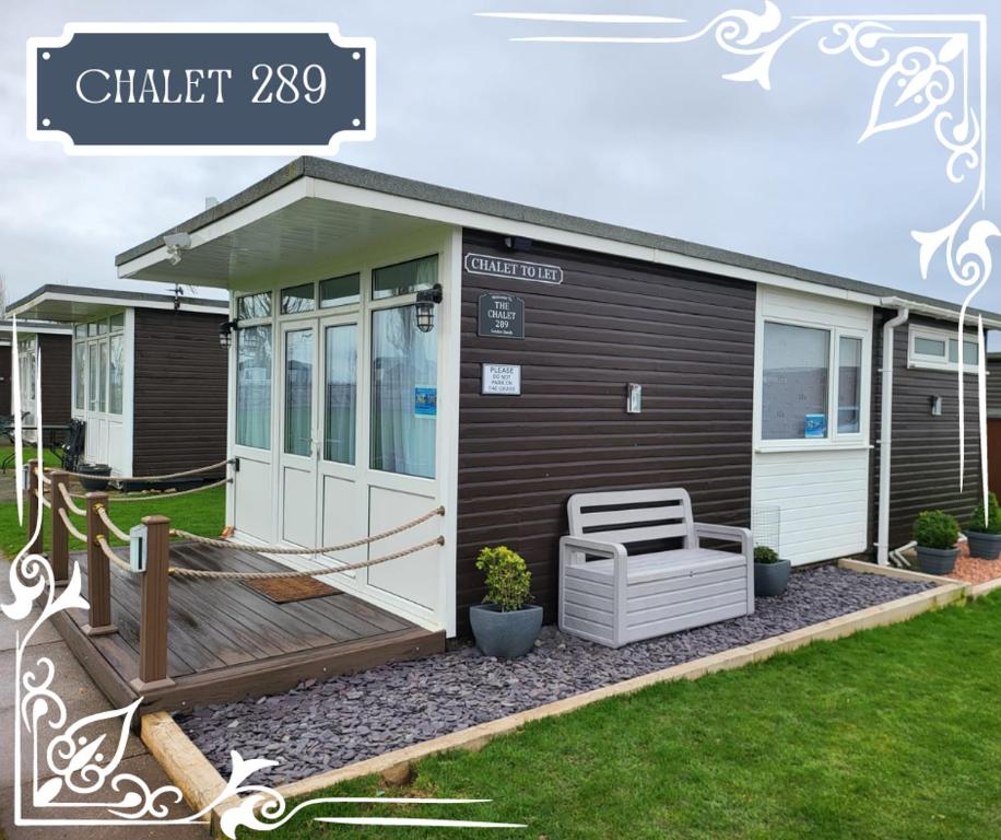 a tiny house with a porch and a deck at THE CHALETS 217 & 289 in Withernsea