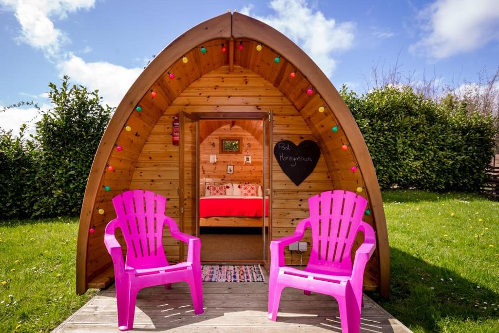 two pink chairs sitting in front of a play tent at Podumna Glamping Village in Portumna
