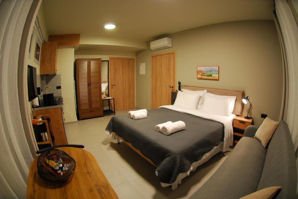 a bedroom with a large bed and a couch at Cruzeto in Syvota