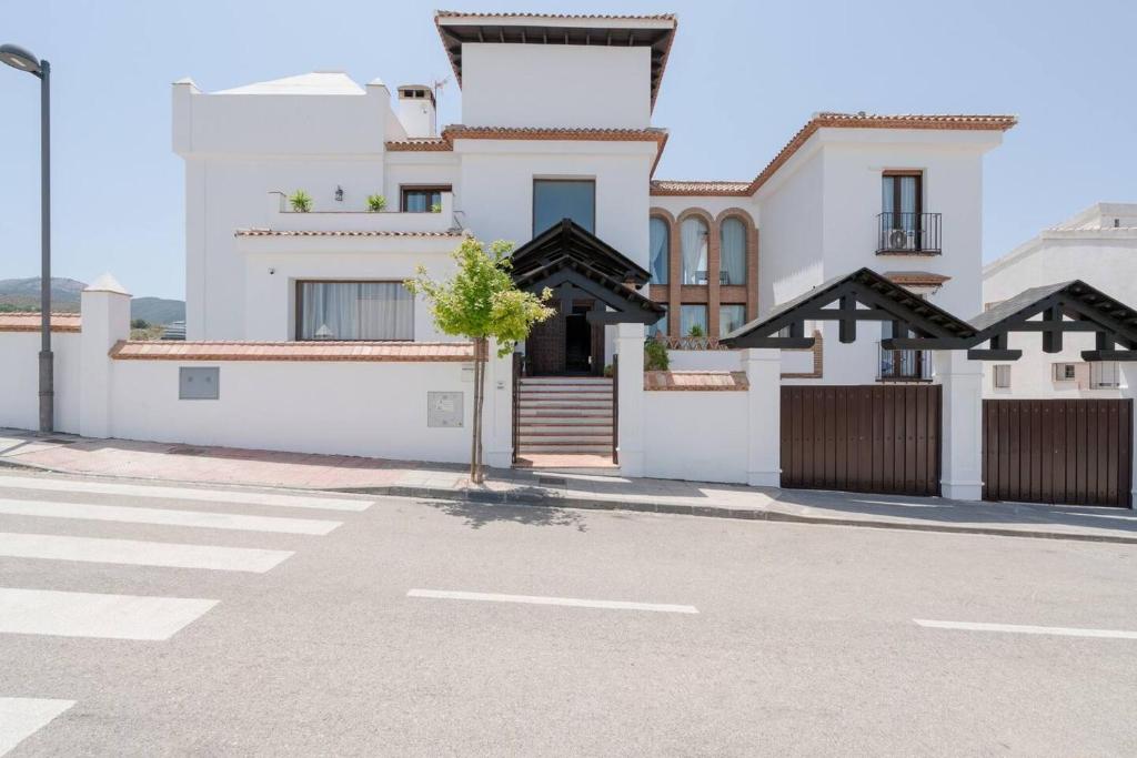 a house on the side of a street at 7 bedrooms villa with private pool jacuzzi and wifi at Granada in La Zubia