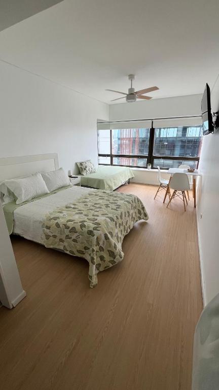 a bedroom with a bed and a ceiling fan at Alto Buenos Aires in Buenos Aires