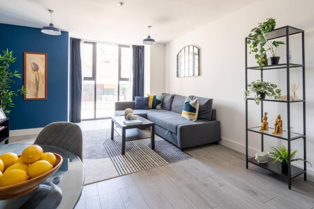 a living room with a couch and a table at Indigo Heaven at Hemel in Hemel Hempstead