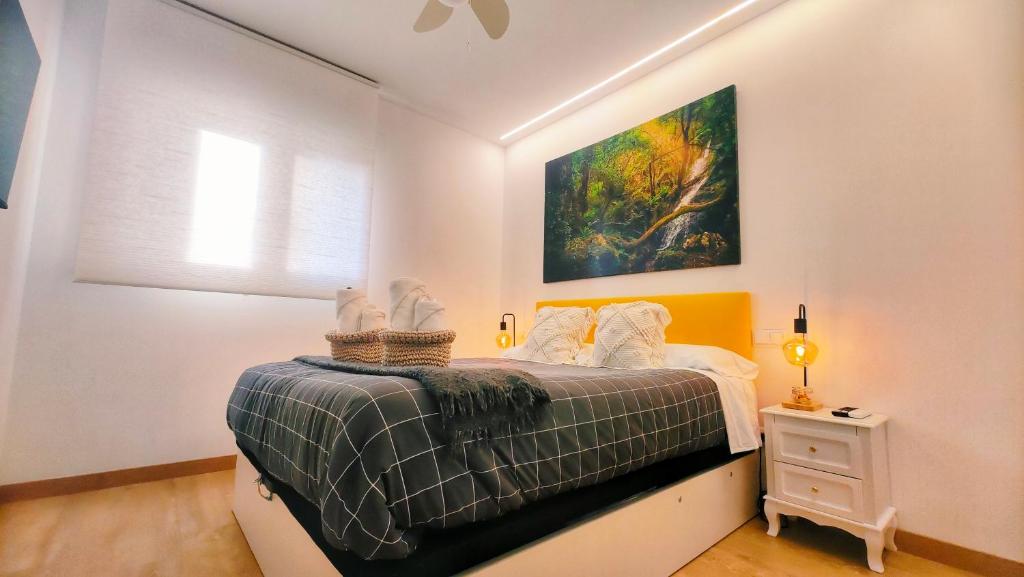 a bedroom with a bed and a painting on the wall at Nuevo Hola Madrid in Madrid