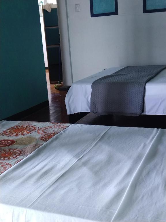 Postel nebo postele na pokoji v ubytování Lajuela BnB & Hostel