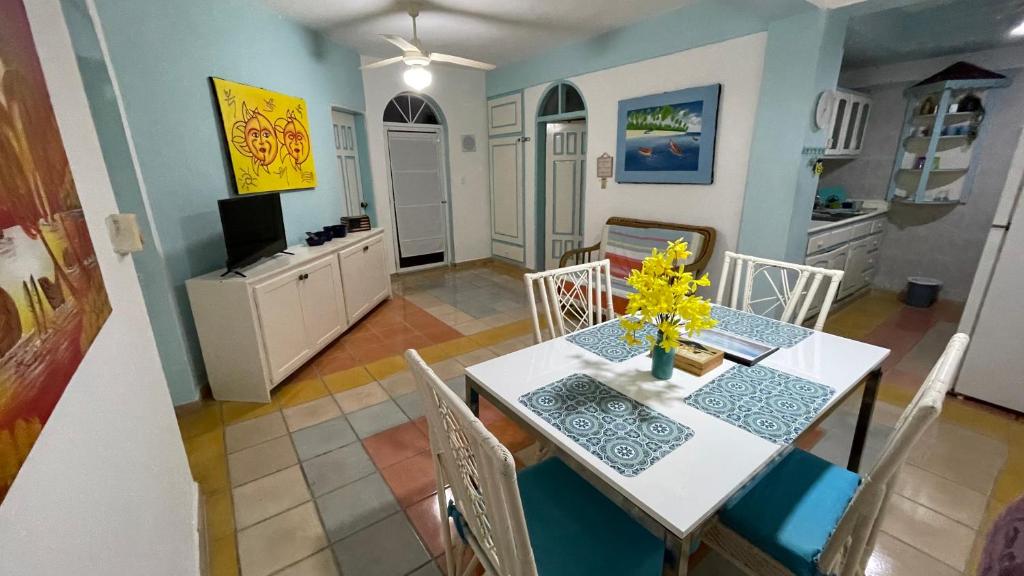 a kitchen and dining room with a table and chairs at Caribbean Paradise steps to DayPass Resort&Beach in La Laguna