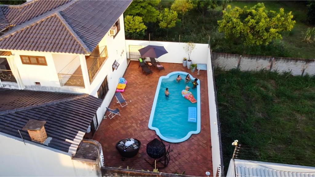 an overhead view of a swimming pool on a patio at The House Foz Do Iguaçu Cataratas e Paraguai in Foz do Iguaçu