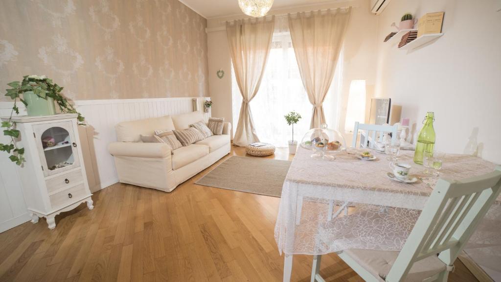 a living room with a table and a white couch at Vatican Sunshine in Rome