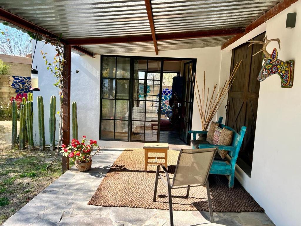 a patio with a table and chairs and a door at Mesquite Tree Retreat in San Miguel de Allende