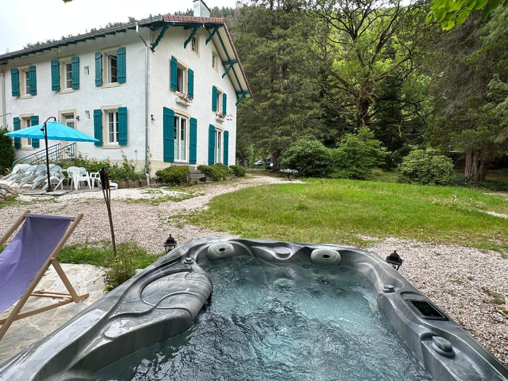 a water slide in the yard of a house at Maison chaleureuse avec cheminée bord de rivière in Gérardmer