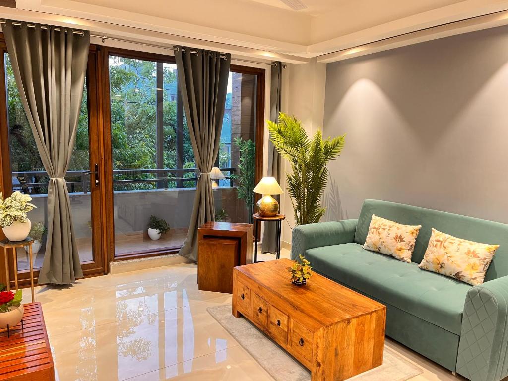 a living room with a couch and a coffee table at Hotel Gianmala Residency South Extension near AIIMS Delhi in New Delhi