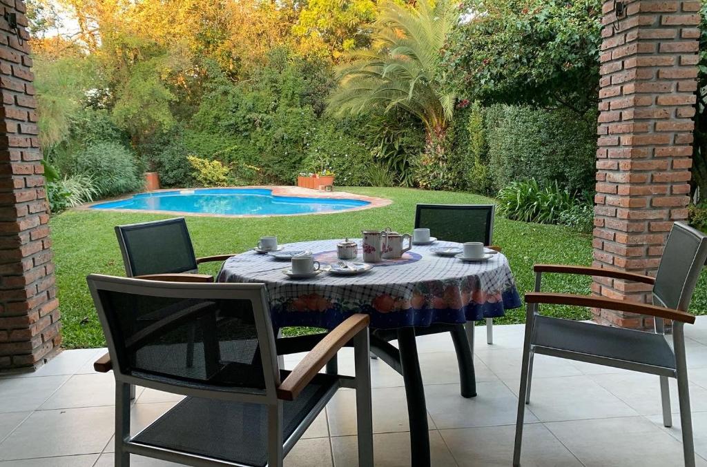 a table and chairs in a yard with a pool at Casa en San Isidro in San Isidro