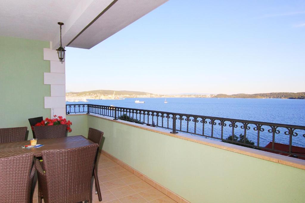 a balcony with a table and a view of the water at HAPPY DAYS in Trogir