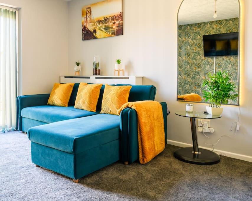 a blue couch in a living room with a table at Stylish Two-bed House Birmingham sleep up-to 6 in Birmingham