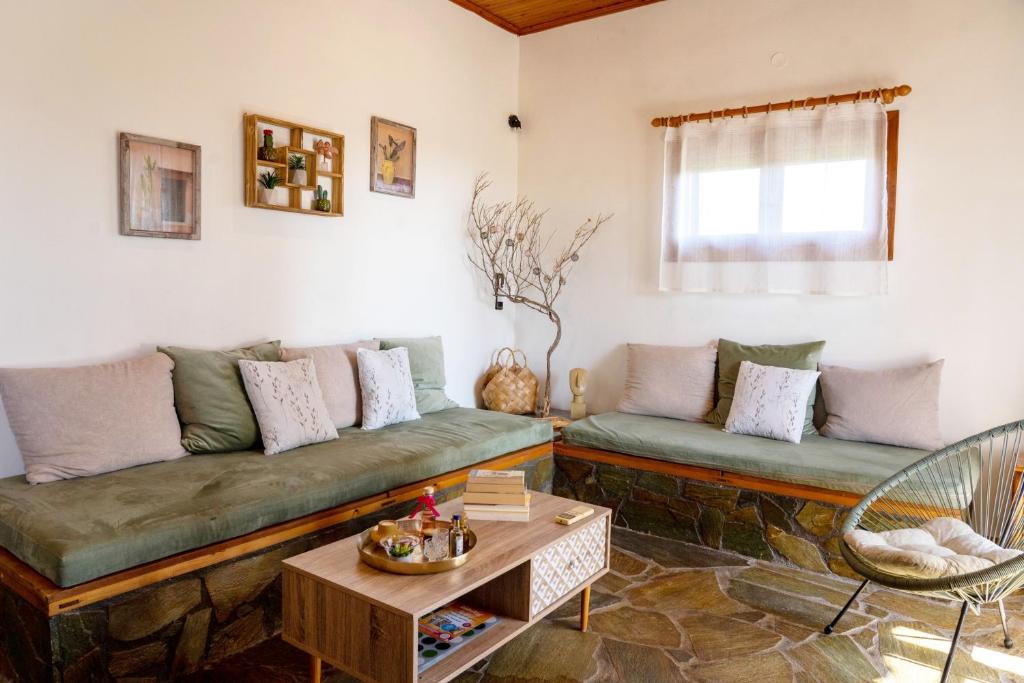 a living room with a couch and a table at Jutta's house in Kallithéa