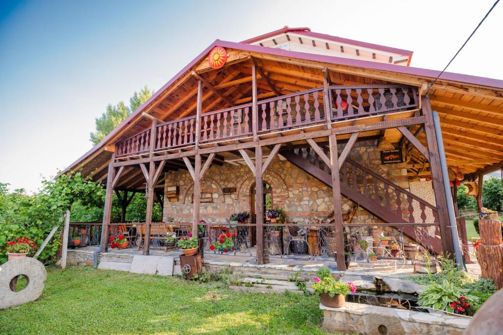 a large wooden house with a large deck at Apartment in Antique Museum Filip in Krklino