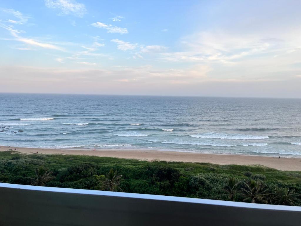 a view of the ocean from a balcony at Stella Maris Flat 93 Amanzimtoti in Amanzimtoti