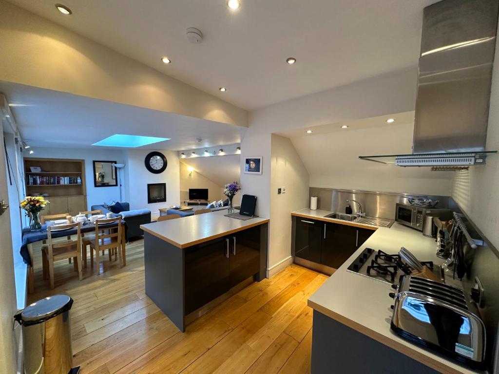 a large kitchen and living room with a dining room at Apartment Thistle Lane in Edinburgh