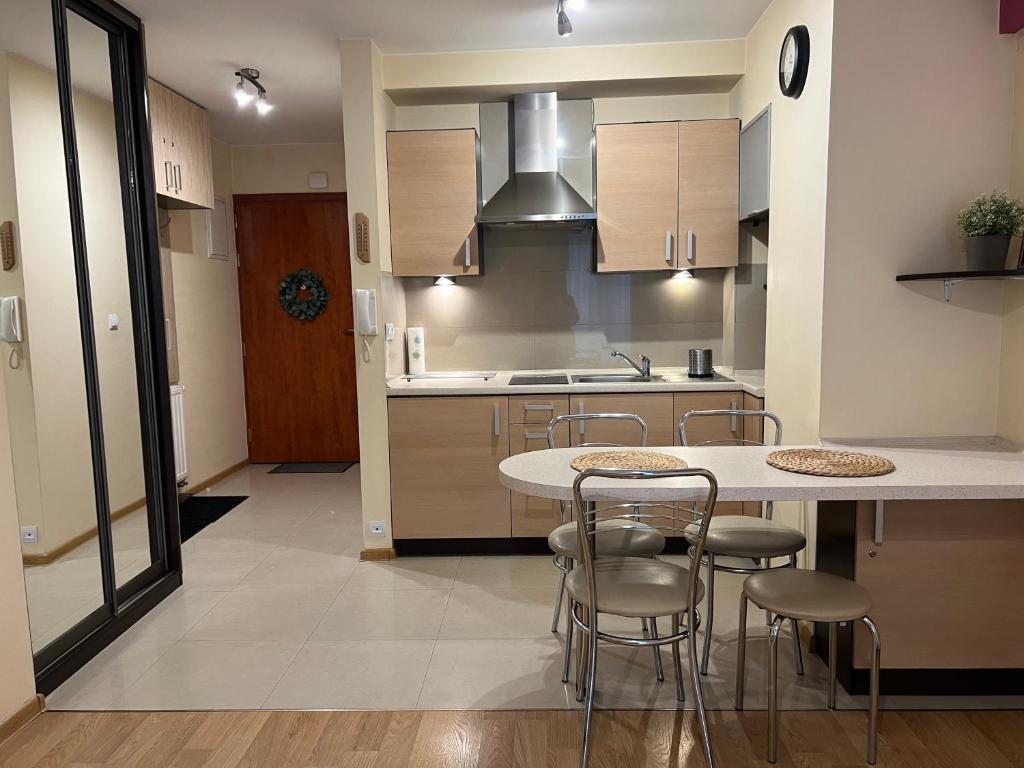 a kitchen with a table and chairs in a room at Ametyst in Krynica Zdrój