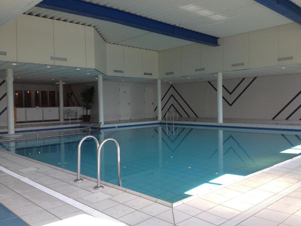 a large swimming pool in a building at Kaap 10 in Hollum