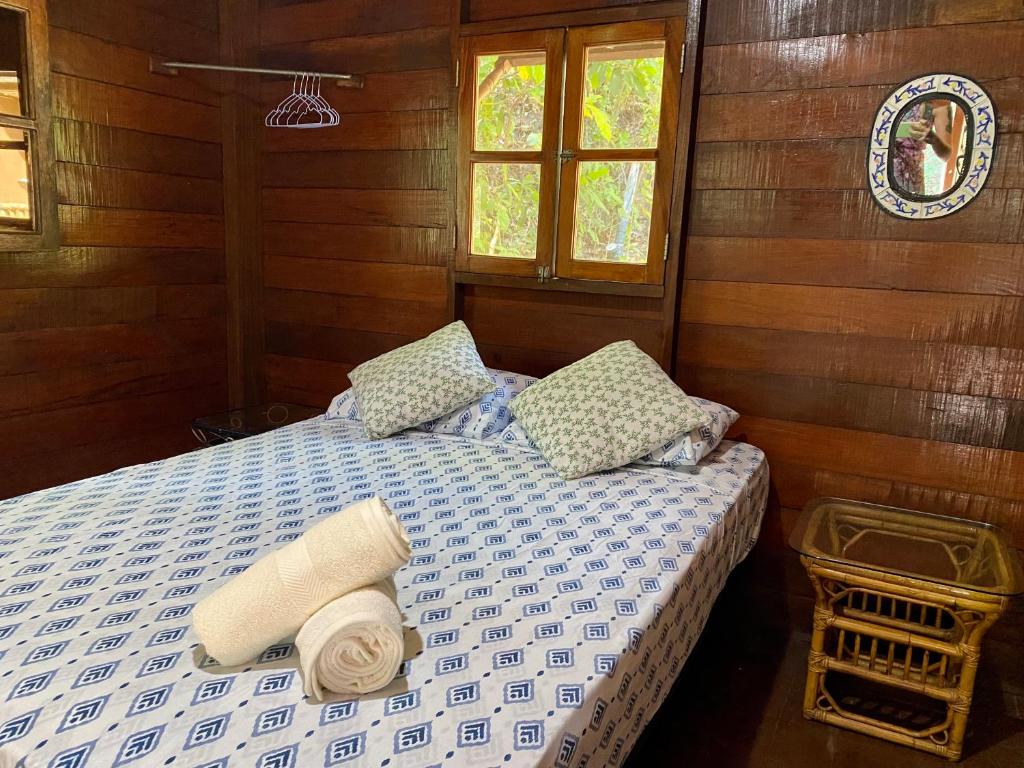 a bedroom with a bed and two pillows at Inti Wasi in San Carlos