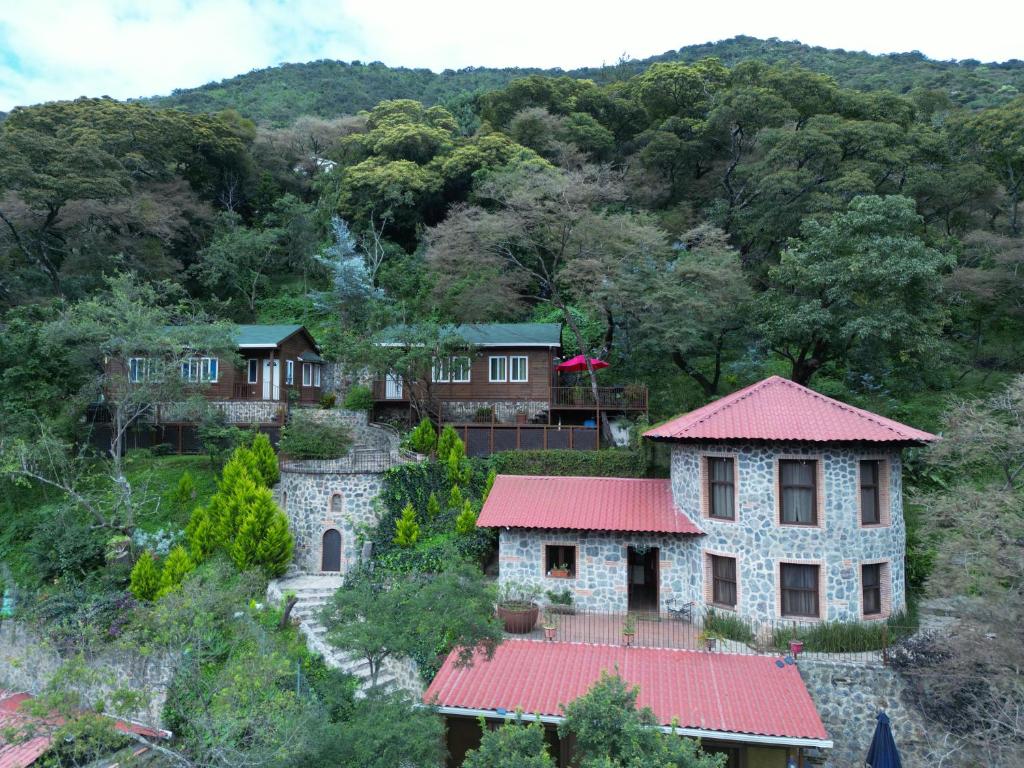un grupo de casas en una colina con árboles en Villas Gasconia, en Antigua Guatemala