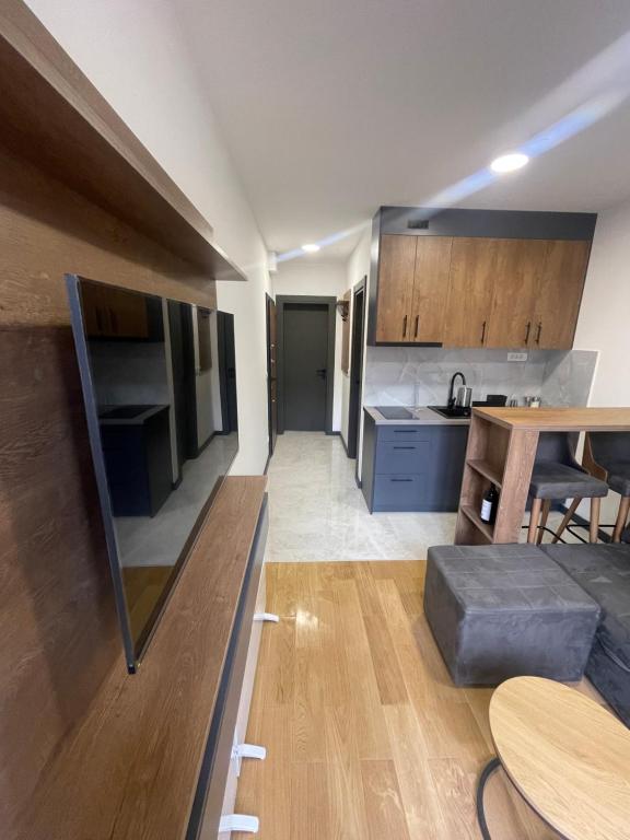 a kitchen and a living room with a table at Jutarnja Zvezda Kop in Kopaonik