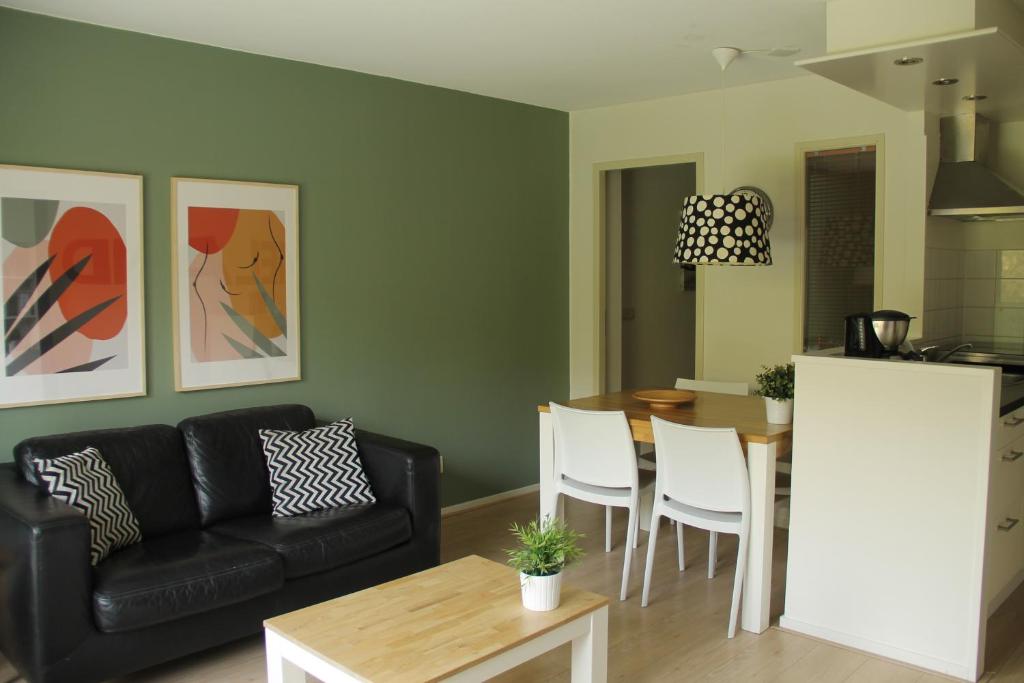 a living room with a couch and a table at Appartement Baken in Hollum
