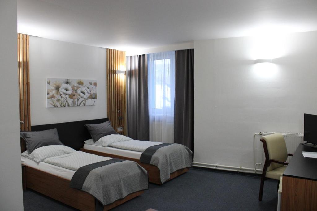 Voodi või voodid majutusasutuse Hotel P7 toas