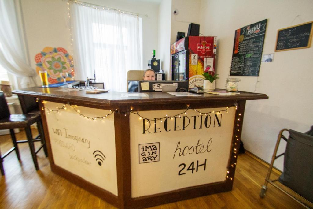 a bar with a sign that reads reception handled at Imaginary Hostel in Tallinn