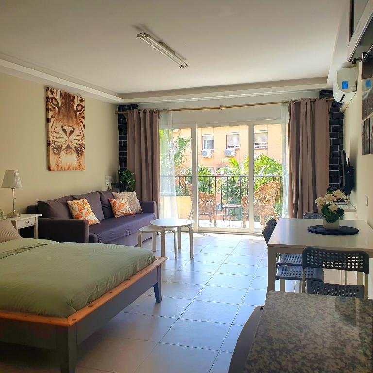 a living room with a bed and a couch at Studio in city in Fuengirola