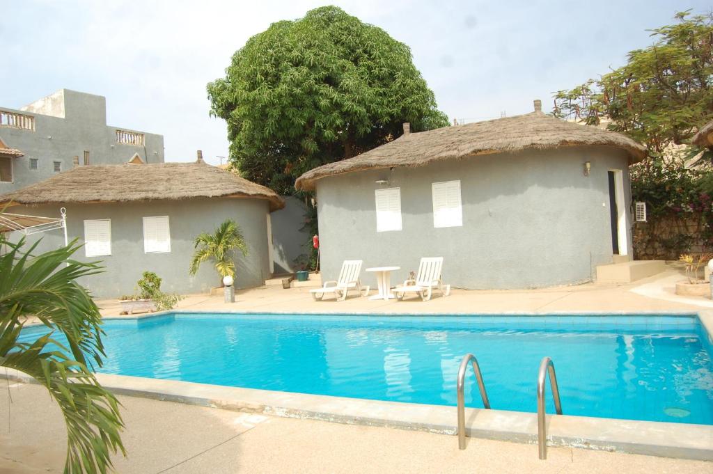 a house with a swimming pool in front of it at Melia's hotel in Sali Nianiaral