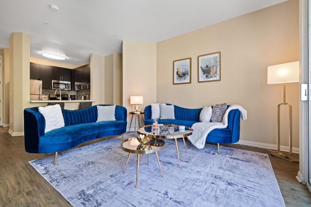 a living room with two blue couches and a table at Venice Marina Pool and Spa Luxury Condo in Los Angeles