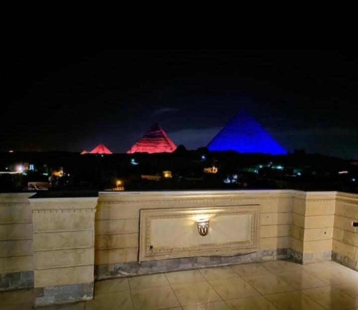 a wall with blue and red lights in the background at 9pyramids hotel in Cairo