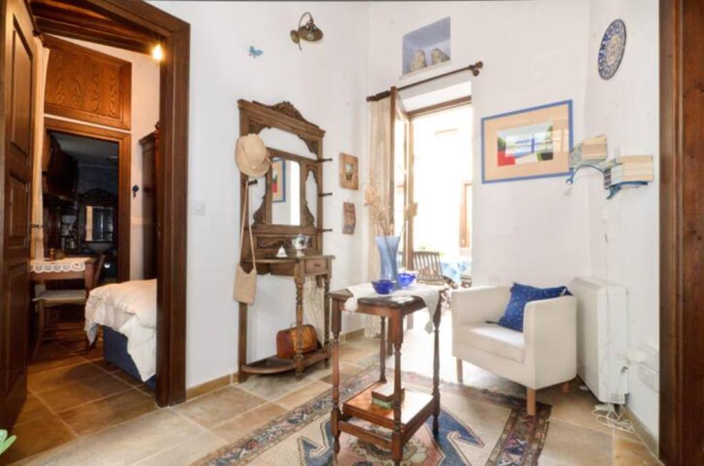 a bedroom with a bed and a chair and a mirror at Studio in the Old City of Nicosia in Nicosia