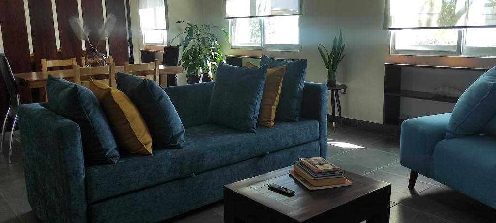 a living room with a blue couch and a coffee table at "Loft Naranjos, live the unique" in Oaxaca City