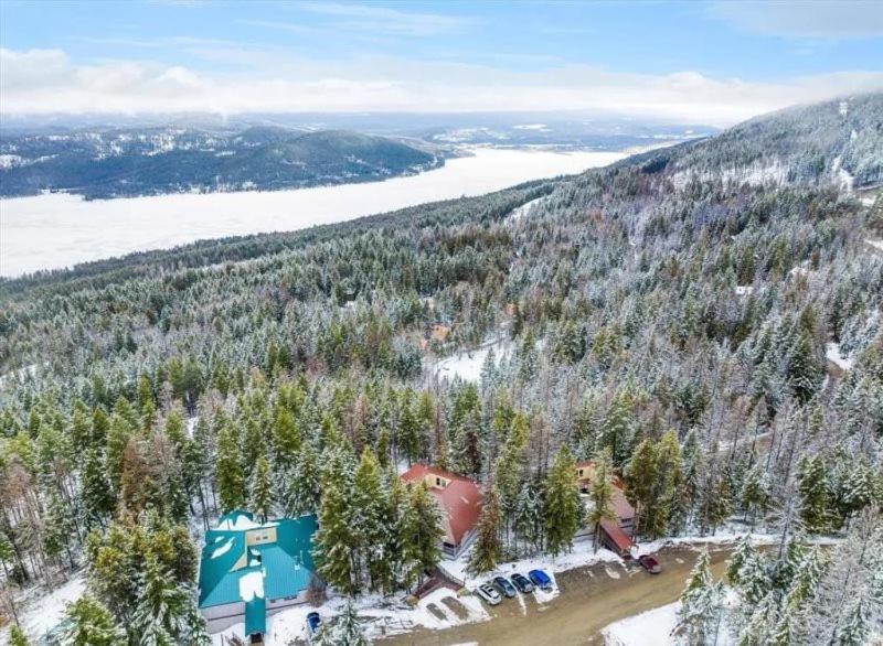 an aerial view of a mountain with trees and a building at Escape to Ptarmigan Village 9 in Whitefish