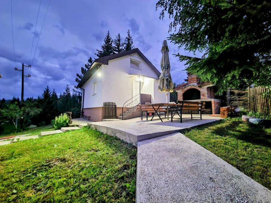 a house with a picnic table in a yard at 7Pines Bijambare - Air Spa in Sarajevo