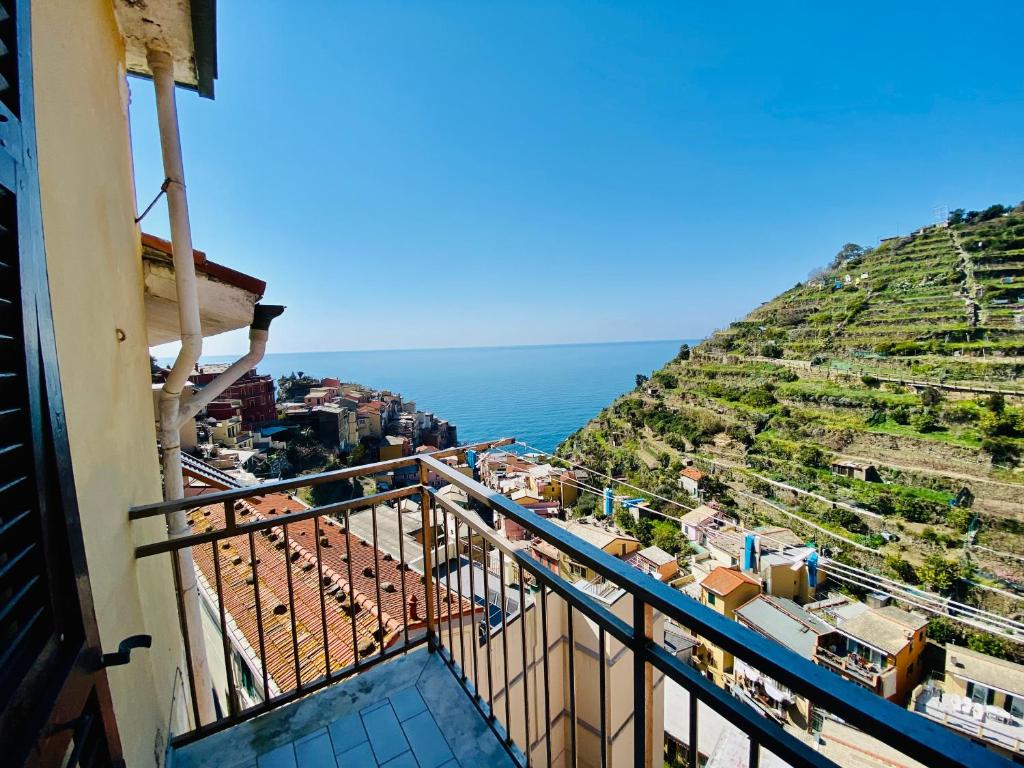 a balcony of a building with a view of the ocean at The Manarola Main Plaza in Manarola