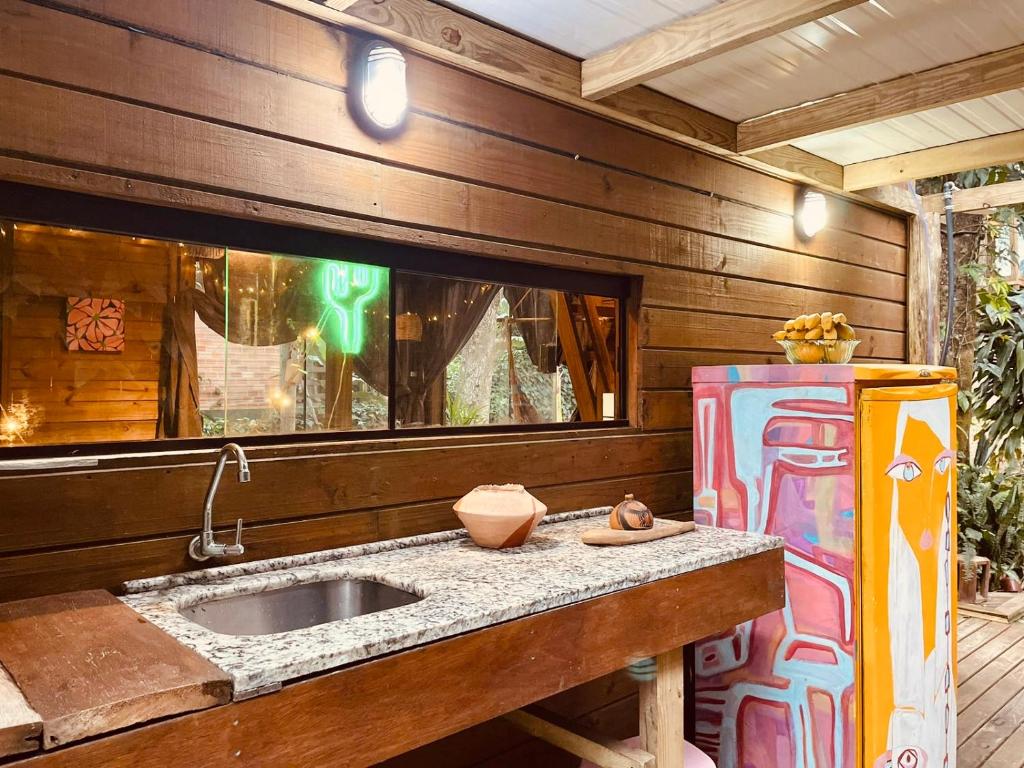 a kitchen with a sink and a refrigerator at CASA JANE in Imbituba