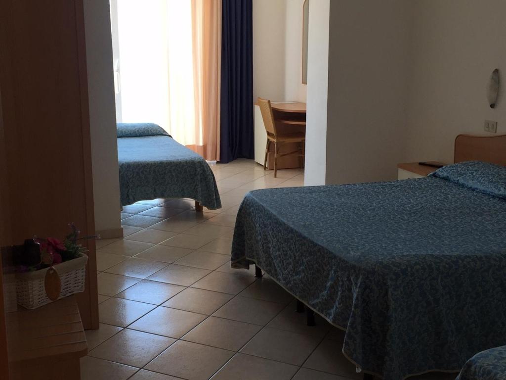 Postel nebo postele na pokoji v ubytování Hotel Lido