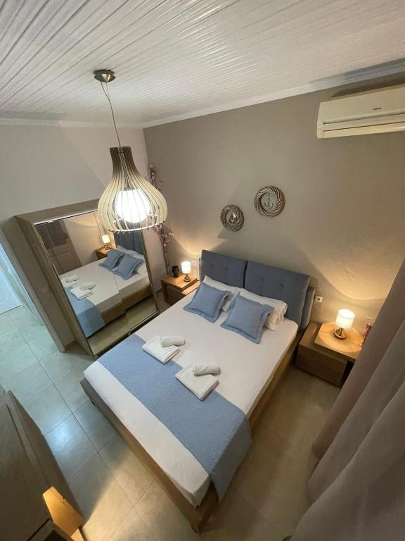 a bedroom with two beds and a mirror at Apartment Nina Holidays in Paralia Sikias